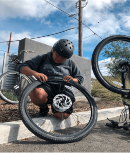 Arlene patching a punctured tube during a group ride to Southwest Community Park