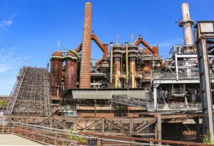 Steel production factory by knollzw found on https://www.needpix.com/photo/1179741/industry-blast-furnaces-steel-production-industrial-heritage-heavy-industry-iron