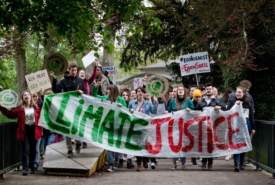 Climate Justice banner at protest. Image via Canva.