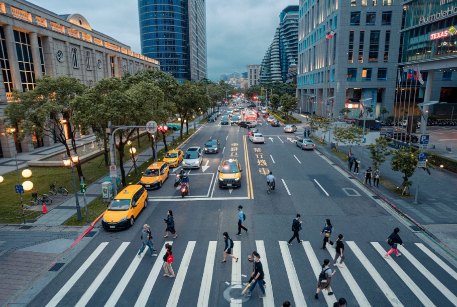 Pedestrians in a cityscape. Image via Canva.