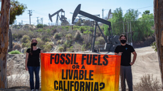 Activists gather near an Inglewood Oil Field in Los Angeles, one of the largest contiguous urban oil fields in the country, to urge the Governor of California to take action to phase out fossil fuels, beginning with those within 2500 feet of homes and other sensitive sites.