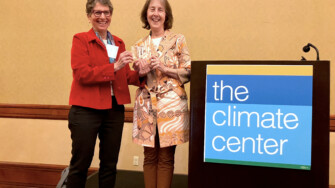 The Climate Center CEO Ellie Cohen presents Senator Nancy Skinner with the inaugural Climate Leadership Award at the 2024 California Climate Policy Summit. Photo by The Climate Center.