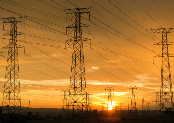 Power lines at sunset. Photo via Canva.